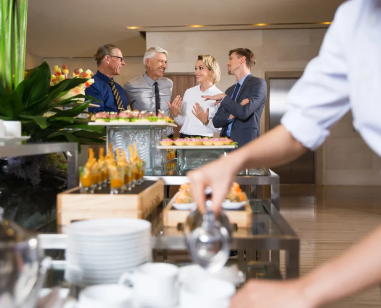 cheerful-business-people-talking-buffet
