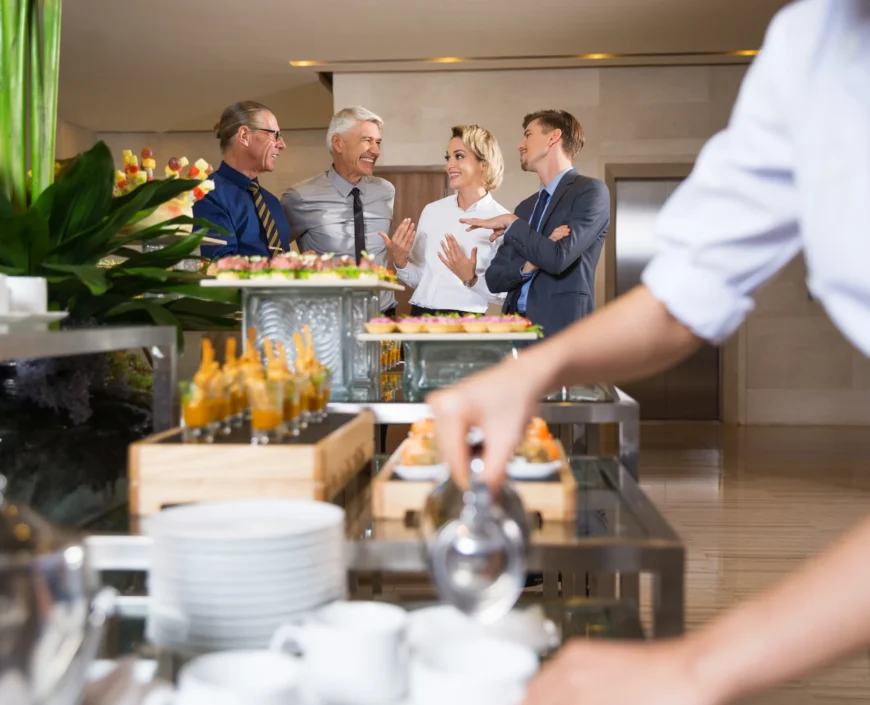 cheerful-business-people-talking-buffet